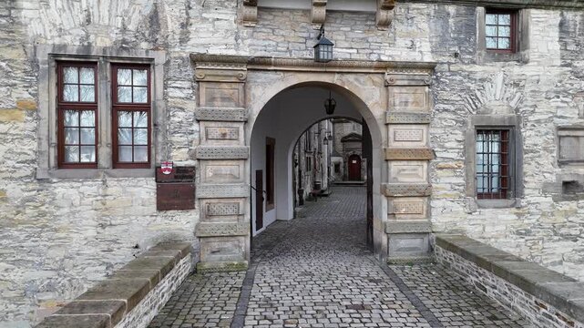 Slow approach toward the castle entrance and emblem