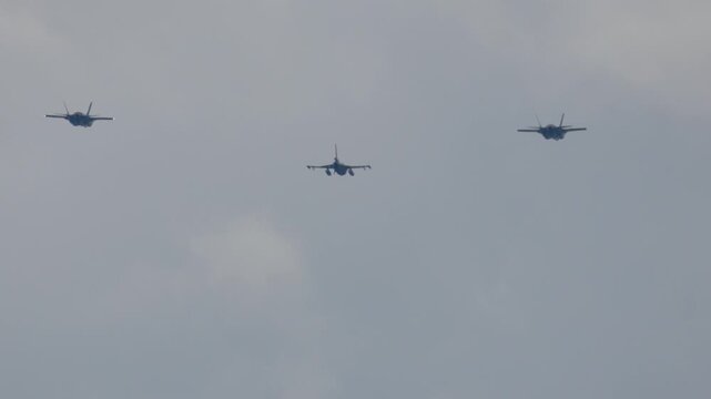 F-35 Lightning II jets in synchronized flight showcasing advanced aerial defense capabilities over military base