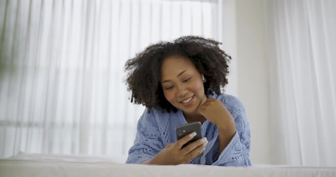 Black African woman with attractive smile use tablet smartphone on white bed, Portrait beauty girl relax in bedroom. Technology people connection digital online marketing e-commerce concept banner