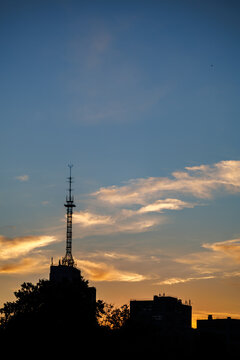 Silhouette of the Derzhprom (Gosprom) building and radio tower at sunset in Kharkiv, Ukraine.