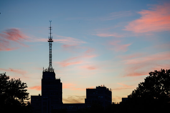 Silhouette of the Derzhprom (Gosprom) building and radio tower at sunset in Kharkiv, Ukraine.