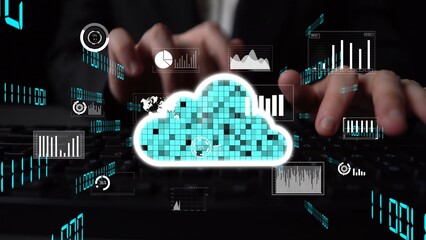 A professional working on a keyboard while interacting with digital data visualizations in a cloud...
