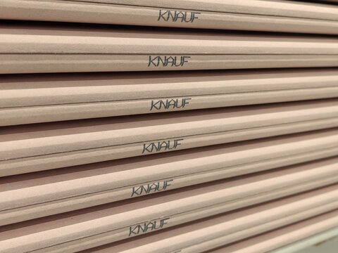 Close Up Stack of Pink Fire Resistant Drywall Sheets