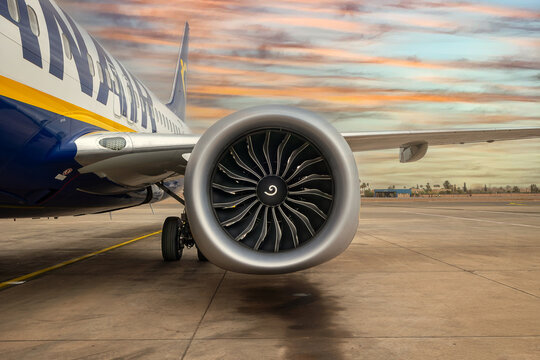 Detail of a Ryanair Boeing 737 MAX 8 engine against a sunset sky at Marrakech-Menara Airport, Morocco.