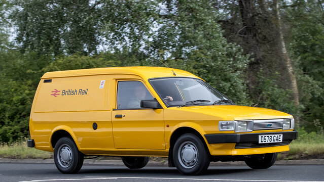 Stony Stratford,Bucks,UK - June 7th 2026:  Yellow British Rail 1987 Austin Maestro van driving on a British road