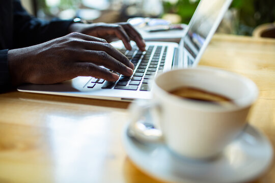 Person typing on laptop at coffee shop