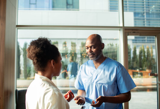Healthcare professional consulting patient in hospital lobby