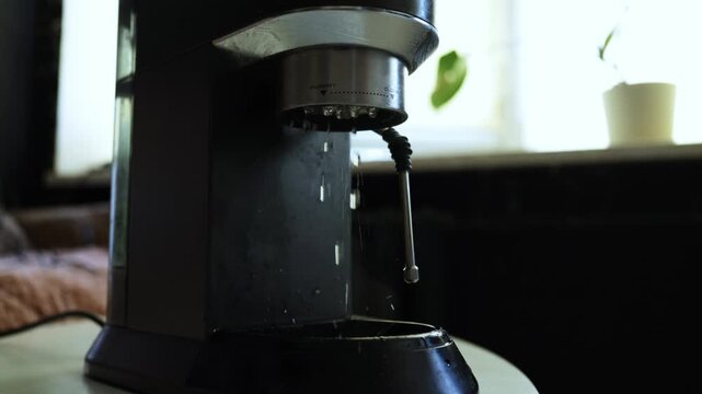 Close-up of a coffee machine dispensing hot water for brewing coffee