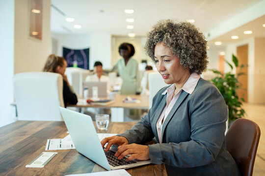 Businesswoman working on laptop in modern office