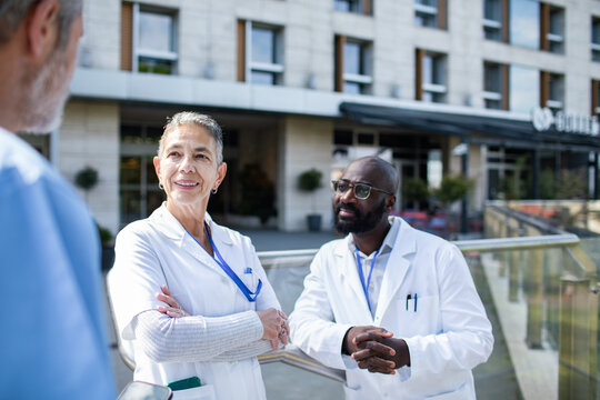 Doctors discussing patient care outside hospital
