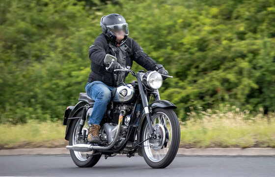 Stony Stratford,Bucks,UK - June 7th 2026:  Man riding a 1960 BSA A10 classic motorcycle driving on a British road