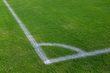 Fototapeta premium Football Field Corner Marking on Fresh Green Grass Pitch Ready for Professional Sports Competition