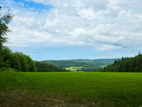 germany, magnificent panoramic view across endless green forested hills under pristine summer blue sky