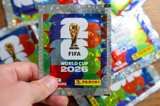 Hand holding Panini FIFA World Cup 2026 trading card sticker packs, foil booster packets for football soccer tournament collectors