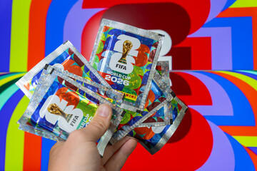 Naklejka premium Hand holding Panini FIFA World Cup 2026 trading card sticker packs, foil booster packets for football soccer tournament collectors