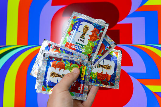 Hand holding Panini FIFA World Cup 2026 trading card sticker packs, foil booster packets for football soccer tournament collectors