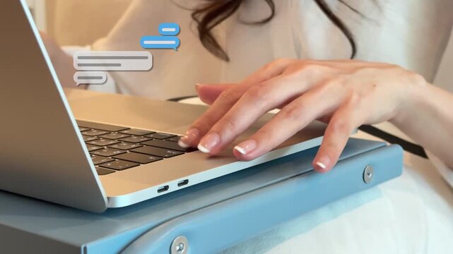 4K close-up of an East Asian woman's hands typing text on a laptop keyboard at home, with floating chat bubbles indicating remote work.