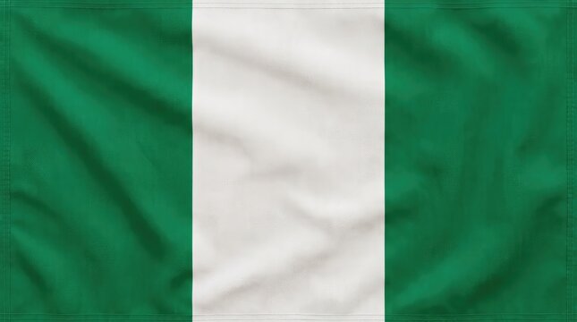 The Nigerian flag waving proudly in the wind, showcasing its vibrant green and white stripes, symbolizing the nation's rich resources and unity