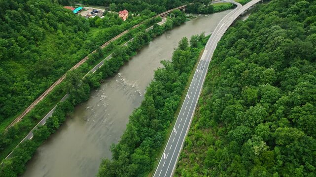 Aerial view of river canyon with road and low clouds