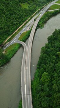 Aerial view of river canyon with road and low clouds