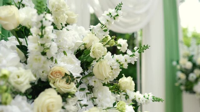 wedding arch of white rose flowers on the river bank before the wedding ceremony of the bride and groom, festive romantic decor	