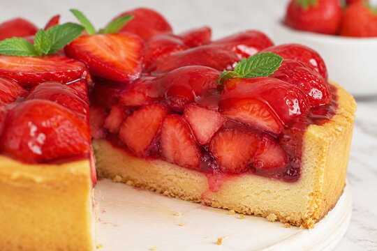 Cake with strawberries, strawberry pie slice close up with fresh berries and glossy filling