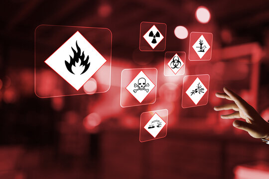 A hand reaches toward digital safety icons on a dark red background, representing hazardous material management, GHS compliance, chemical risk assessment, and laboratory safety protocols