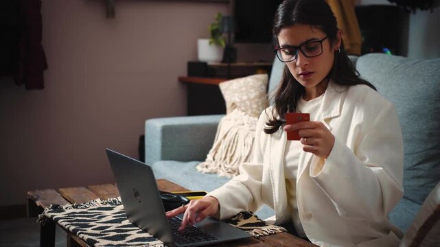 4K video of a young businesswoman shopping online with her credit card. E-commerce, digital payments, consumer behavior and modern lifestyle concept.
