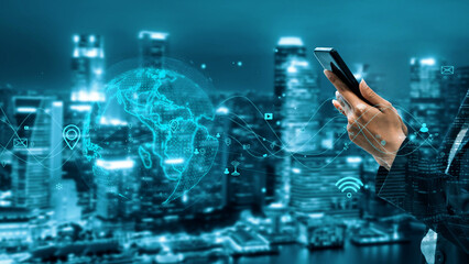 A person holds a smartphone in a futuristic urban setting, highlighting the themes of technology, globalization, and modern communication in the digital age. Xenic © InfiniteFlow