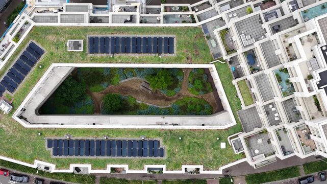 Sustainable green roof building with solar panels aerial view