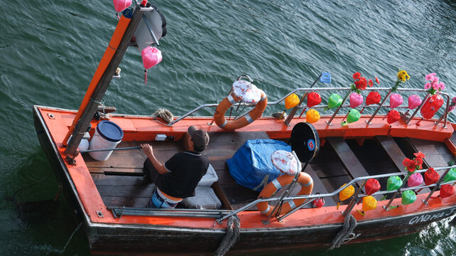 A Passenger Boat Navigating The River In Hoi An