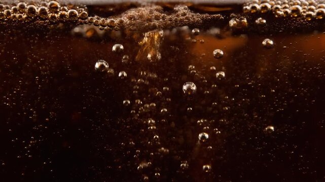 Extreme Macro Shot of Sparkling Carbonation Bubbles in Dark Cola Liquid, Refreshing Fizzy Soda Motion Background