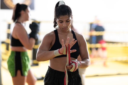 Female Boxer Wrapping Hands in Gym Ring Preparing For Training and Sparring Session