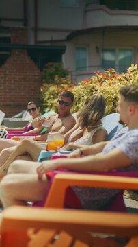 Friends enjoy refreshing summer drinks while relaxing outdoors. They are toasting and sharing good times under the sun.
