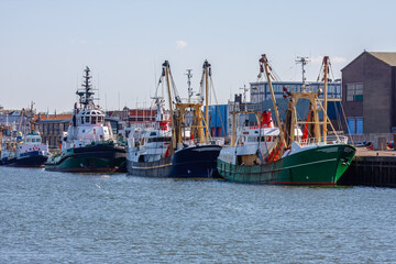 Fototapeta premium Fishing boats and tugboat docked in IJmuiden harbor