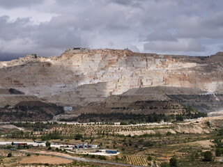 Fototapeta premium Marble quarry exposed to rays of sunlight on a cloudy day in Alguena, Spain
