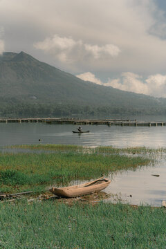 Scenic view of Mount Batur from Batur lake. Isolated by cloudy sky. Wide composition. Travel, nature, Landscape background