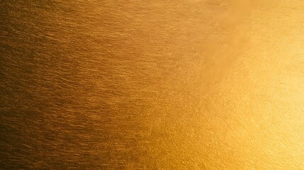 Naklejka premium A clean luxurious golden background surface featuring subtle ambient light and a high texture