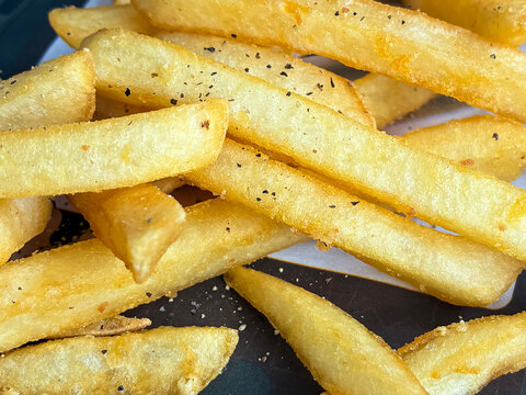 Close up of french fries and pepper.