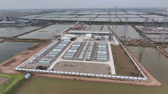 Aerial view of a large-scale energy storage power station facility with battery modules and surrounding infrastructure