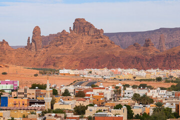 Obraz premium AlJadidah district of AlUla town against red sandstone cliffs, Saudi Arabia