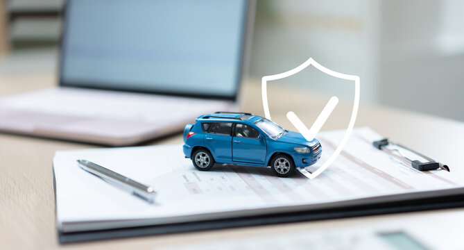 Car on insurance documents with a protection shield icon, representing auto insurance, vehicle coverage, risk management, policy protection, claims processing, and financial security.