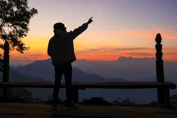 Fototapeta premium male backpacker traveling alone in forest wild. Attractive man traveler look around and explore world while walk in nature wood with happiness on outdoor holiday vacation trip.