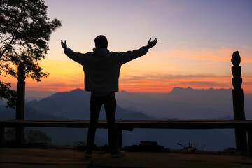Fototapeta premium male backpacker traveling alone in forest wild. Attractive man traveler look around and explore world while walk in nature wood with happiness on outdoor holiday vacation trip.