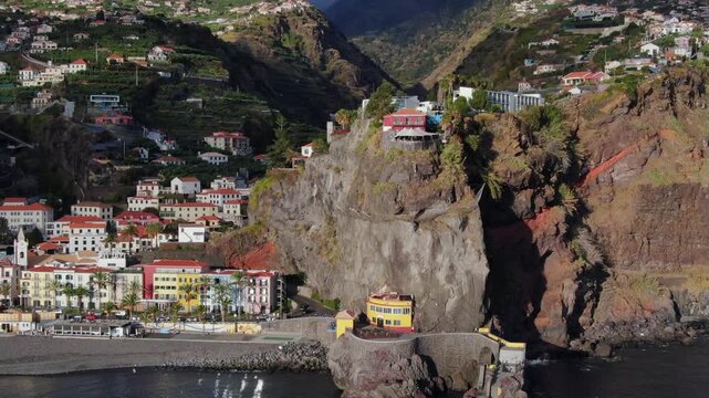 Stunning aerial perspective of the charming coastal village of Ponta do Sol on the island of Madeira, featuring its iconic bridge and dark sand beach