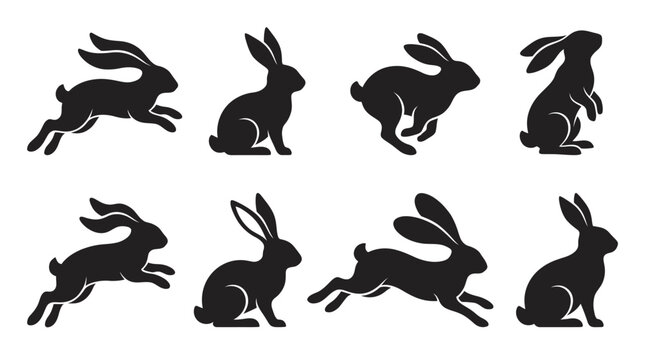 Set of black silhouettes of rabbits in various poses isolated on a white background.