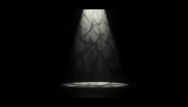 Spotlight shines downward onto a dark surface creating a circular pool of bright illumination that contrasts sharply with the surrounding pitch black environment in this minimalist scene.
