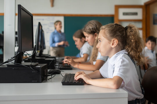 Elementary School Girl Using Desktop Computer During ICT Lesson