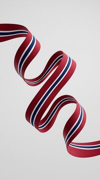 Beautifully Curled Ribbon in Norwegian Flag Colors Red and Blue Representing National Pride and Constitution Day Syttende Mai Celebrations for Decorative Festive Designs on Light Gray Surface