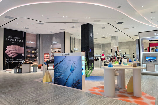 Kuala Lumpur, Malaysia - May 28, 2026: A wide interior view of high-end retail spaces featuring Herm&egrave;s fragrance displays, Mulberry boutiques, and luxury designer brands at Seibu department store.